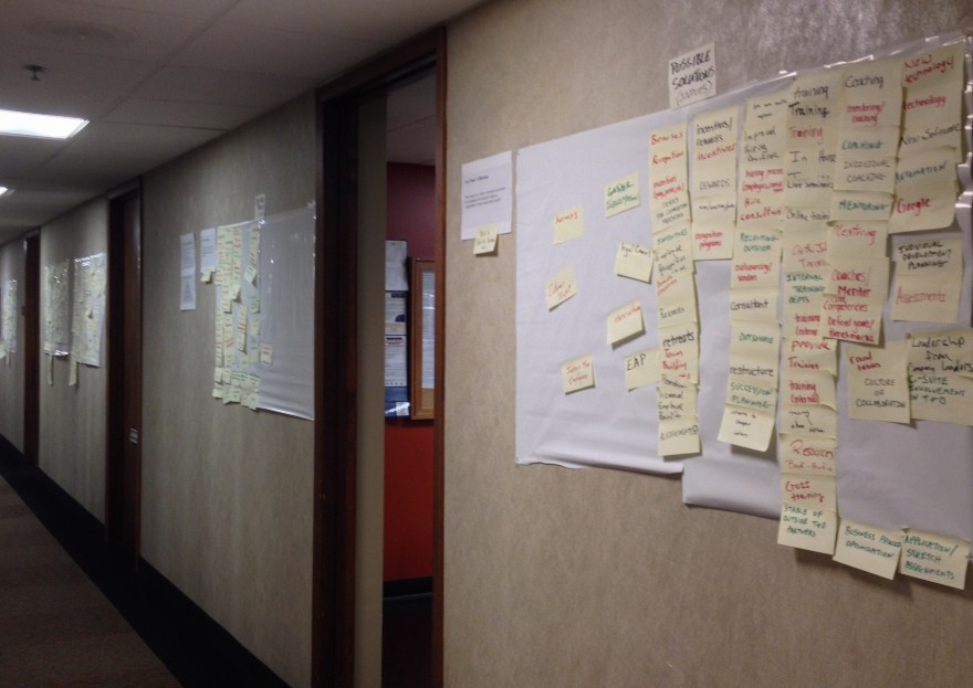 Research boards hung with workshop artifacts in the hallway